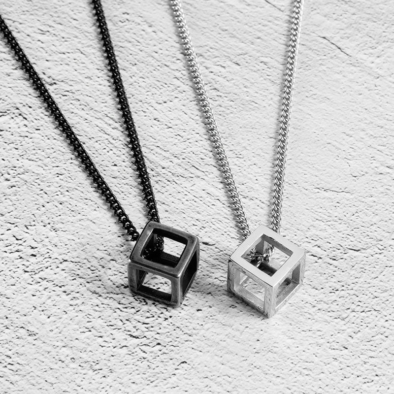 Hollow Cube Necklace both colors lying